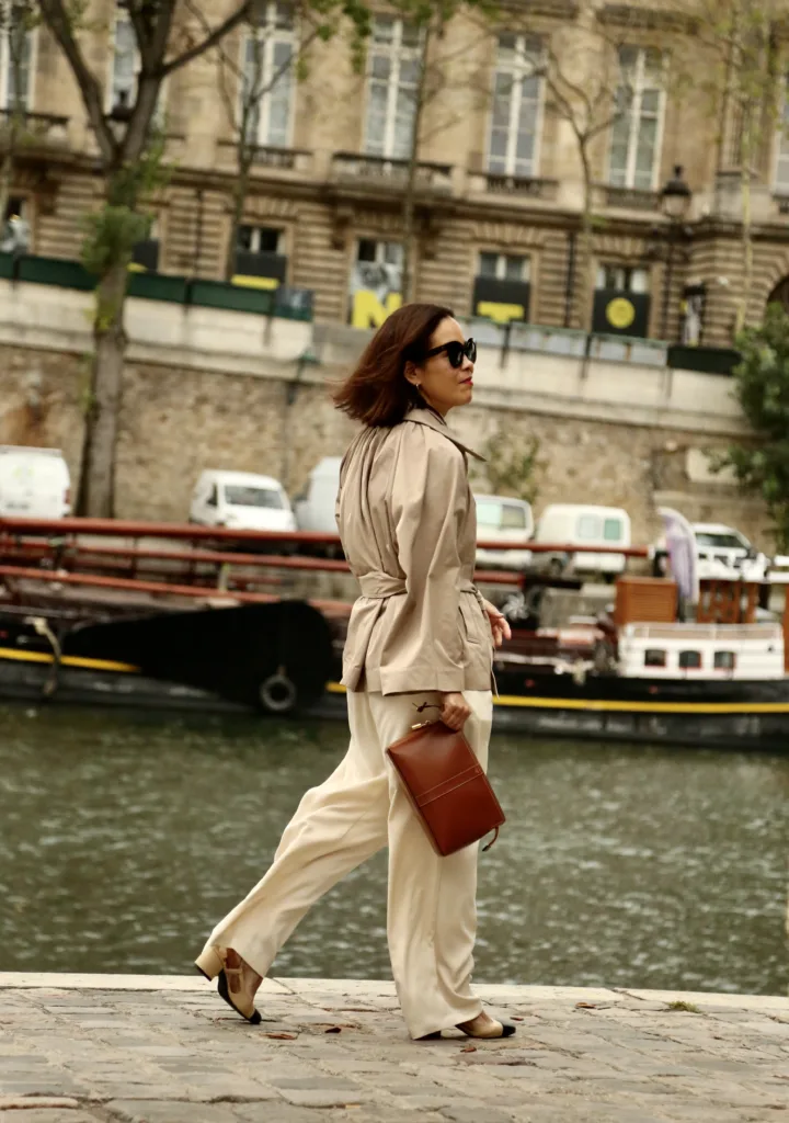 Woman walking on Seine with brown clutch