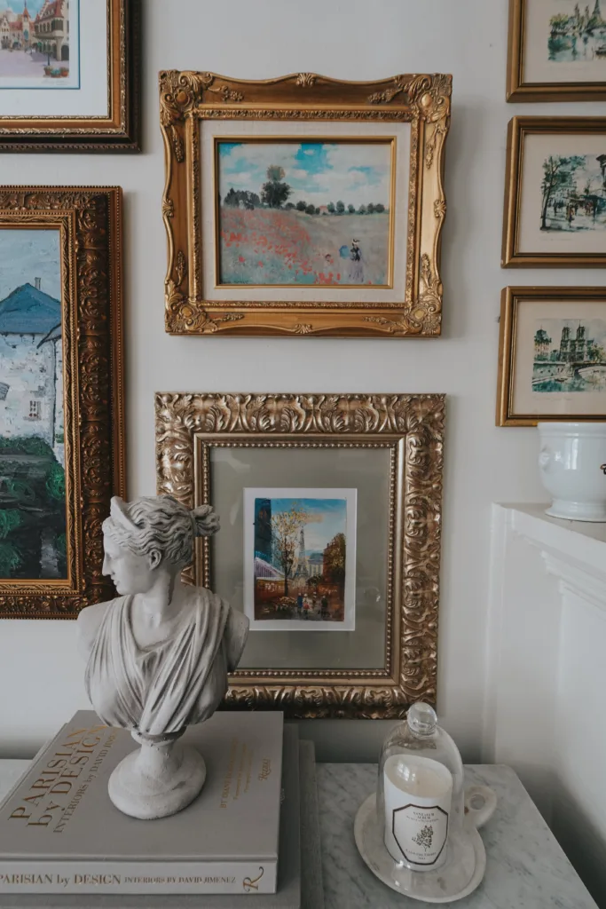French wall art with a bust on a marble console.
