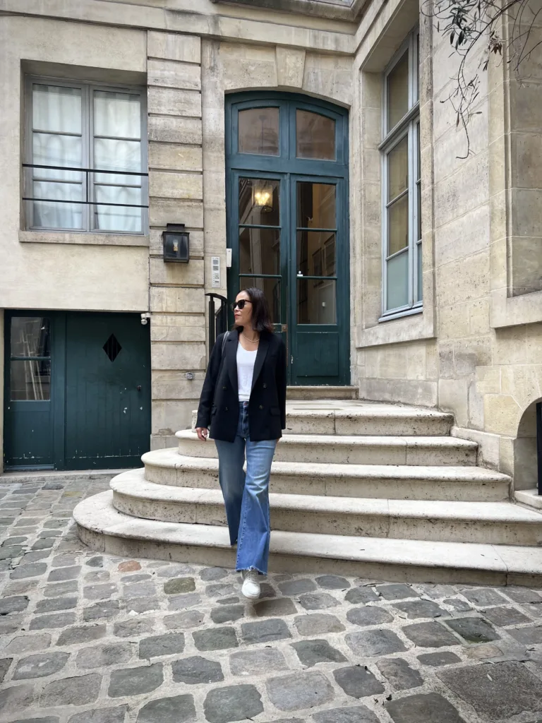 black blazer with sneakers Parisian street style in October black blazer with sneakers and wide leg denim.