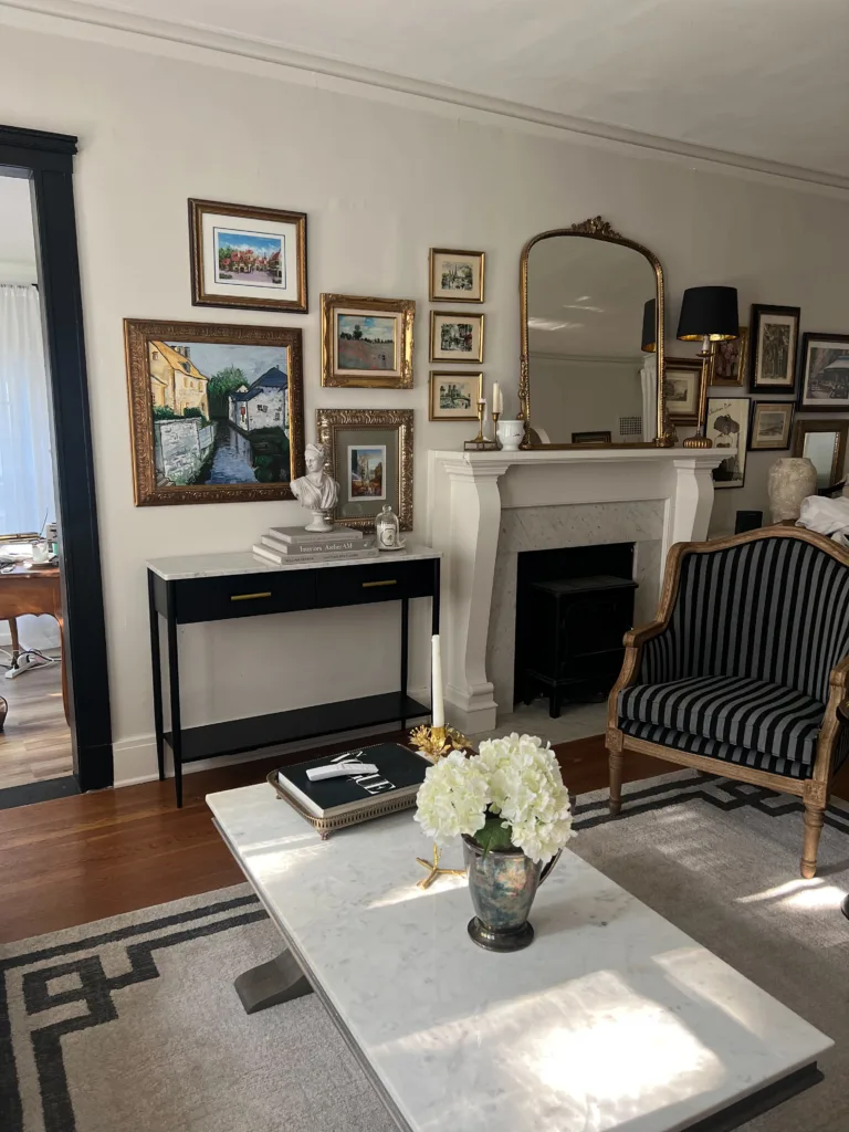 Marble table in living room with stripe chairs.