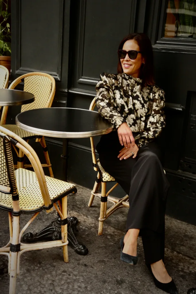 parisian inspired outfits in gold and black Woman sitting for parisian inspired outfits in gold and black.