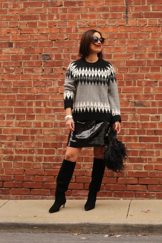 Woman in sequin skirt and sweater.