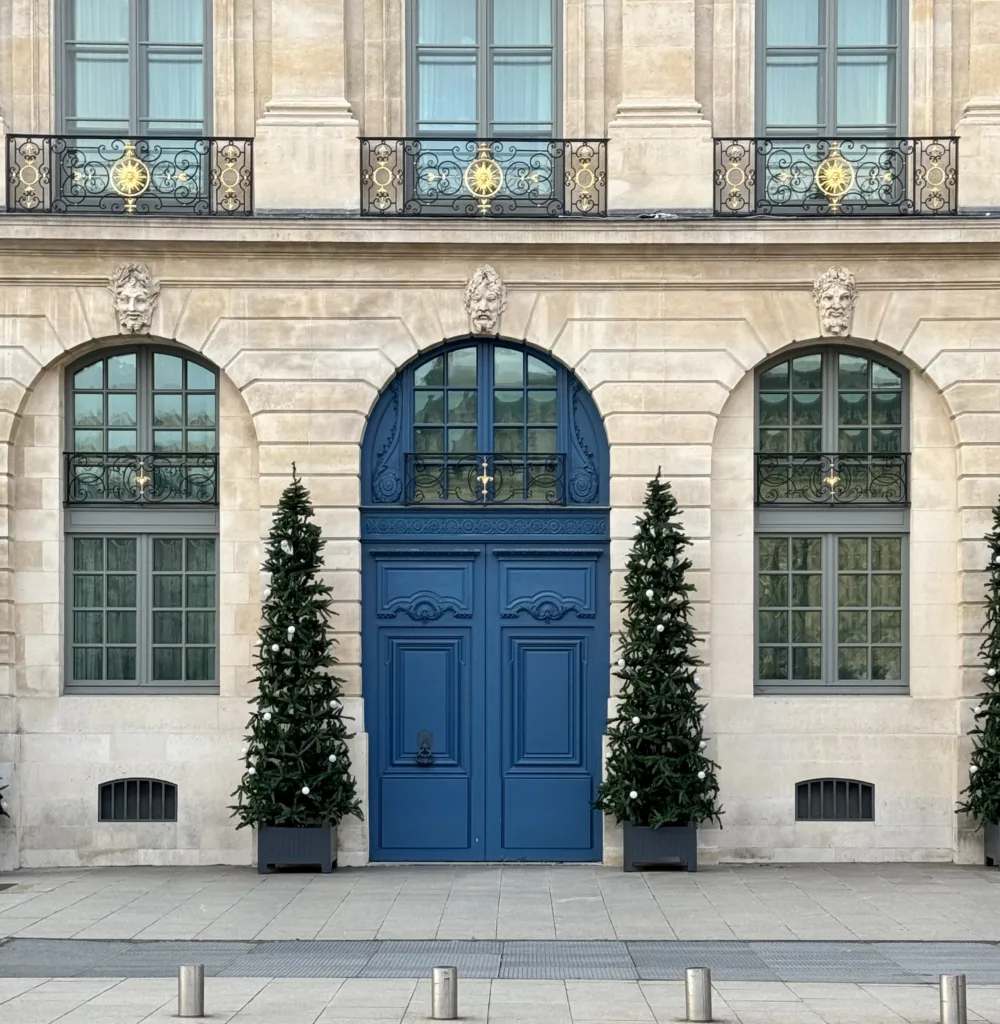 Two blue doors in Paris with christmas trees.