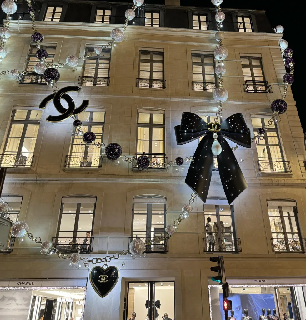 Chanel in Paris at night with big pear necklace | Where To See Festive Sights In Paris