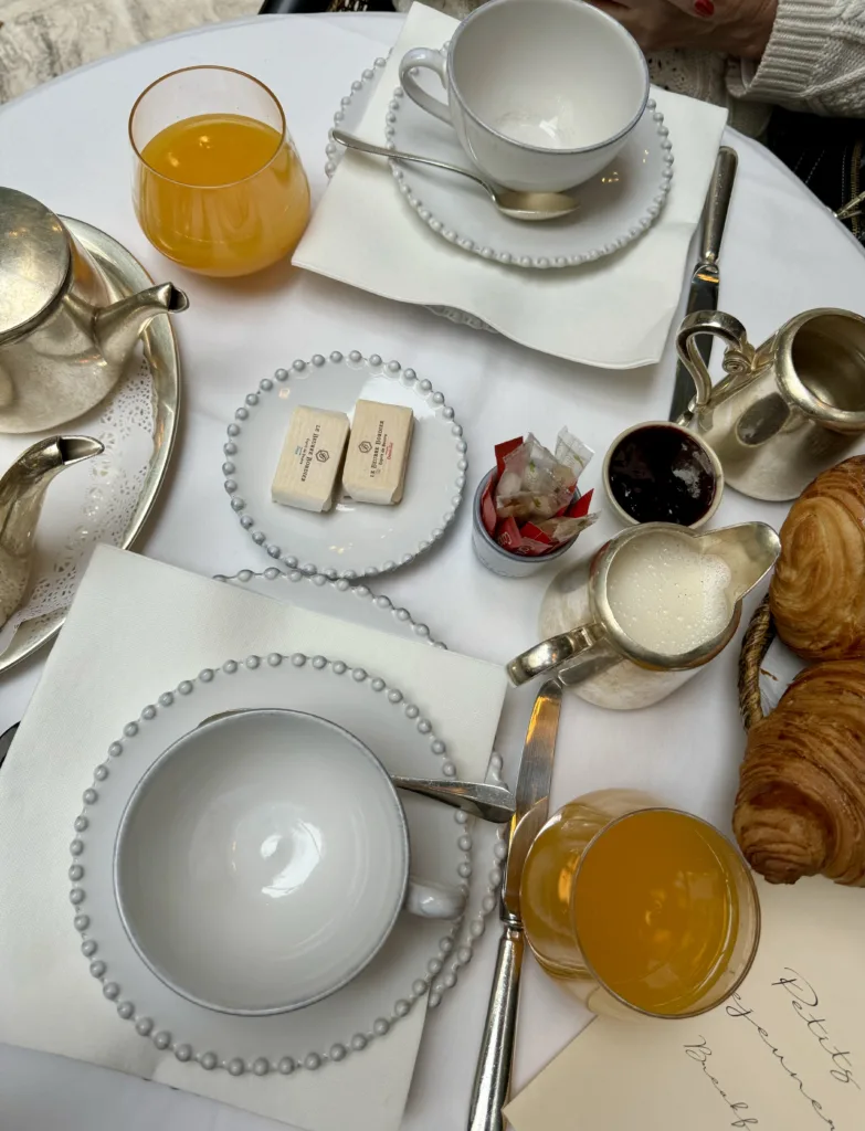 Dishes with butter and orange juice on table in Paris.