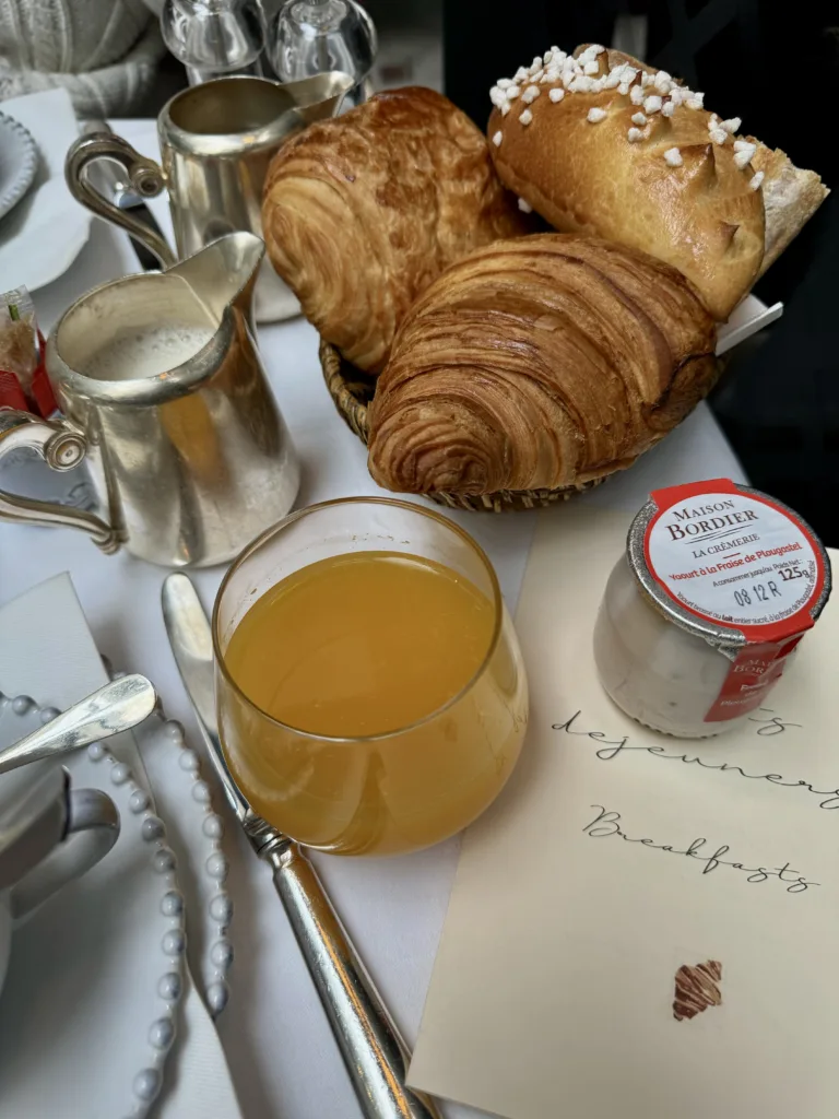 Croissant and Juice on breakfast table.