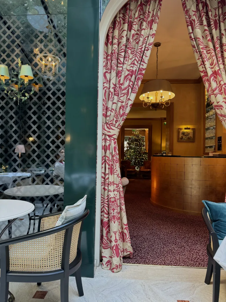 Breakfast room at hotel with red and white curtains, chairs.