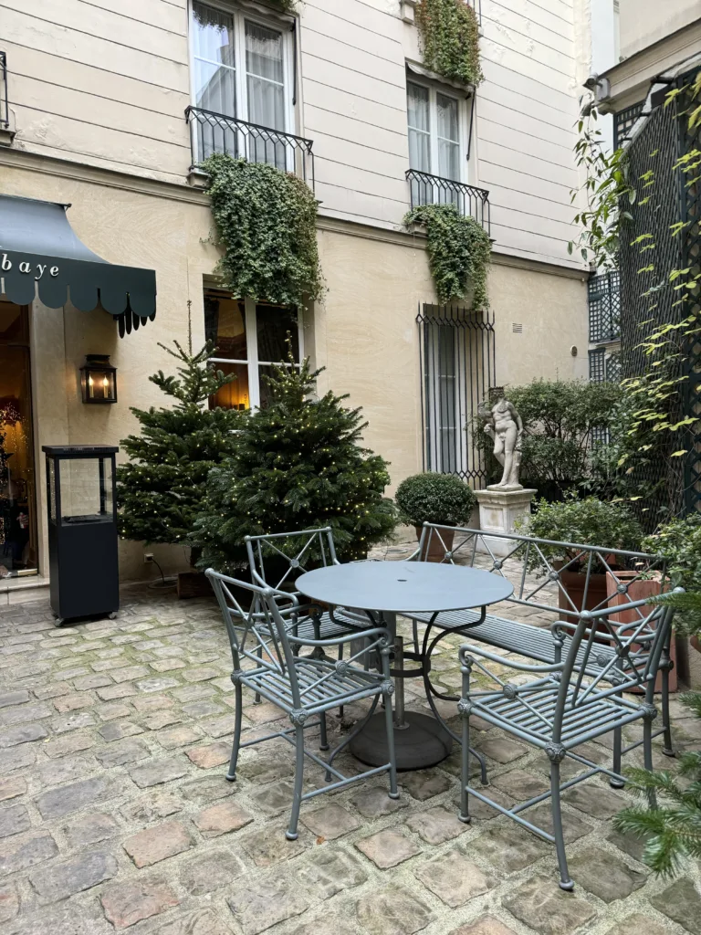 Exterior patio table of hotel l'abbaye in Paris.