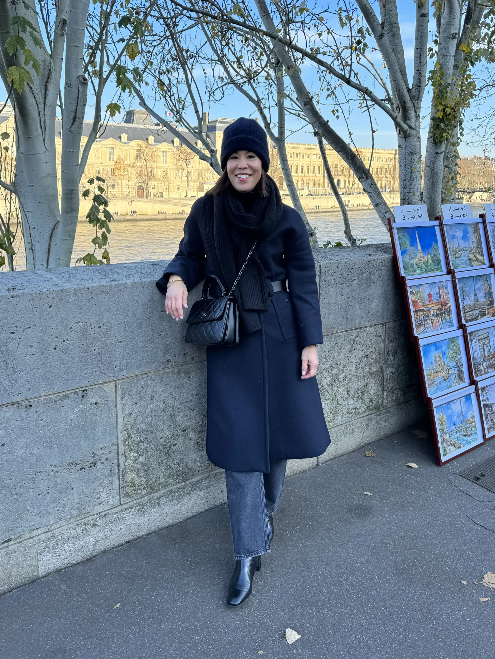 What To Pack For Paris In Winter with a navy wool coat and boots.