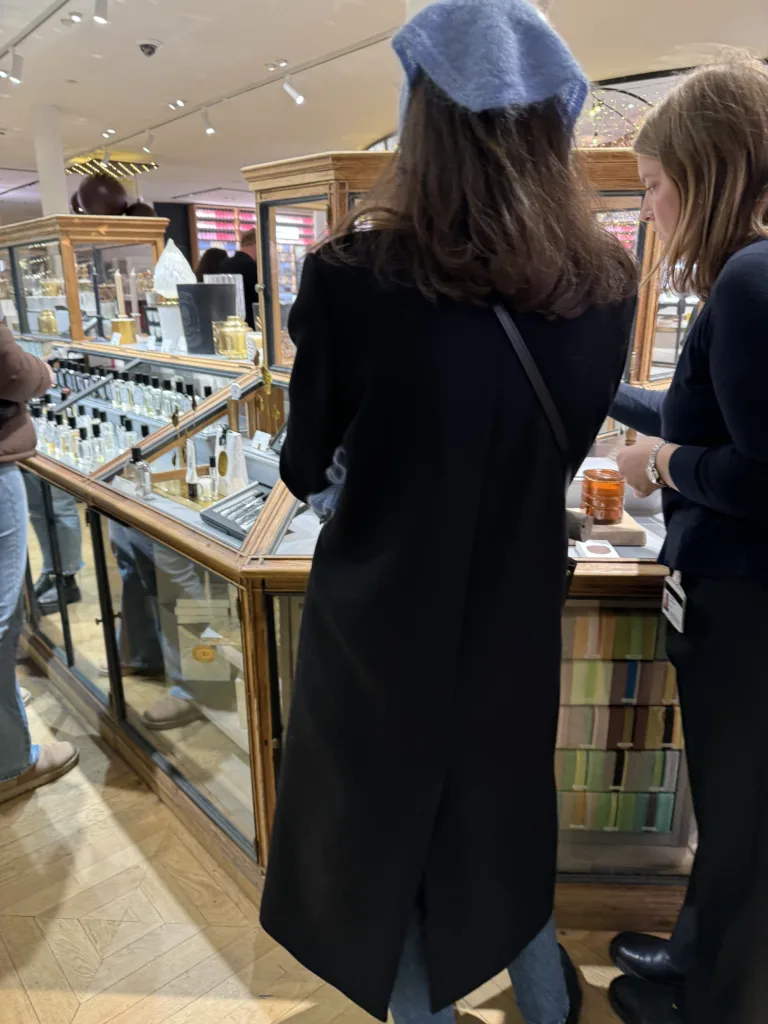 Packing for Paris in the winter wearing a wool coat and scarf.