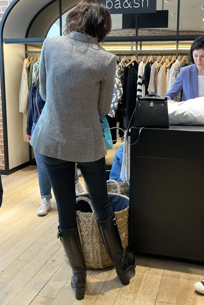 Packing for Paris in Winter to look stylish in tall boots and jeans.