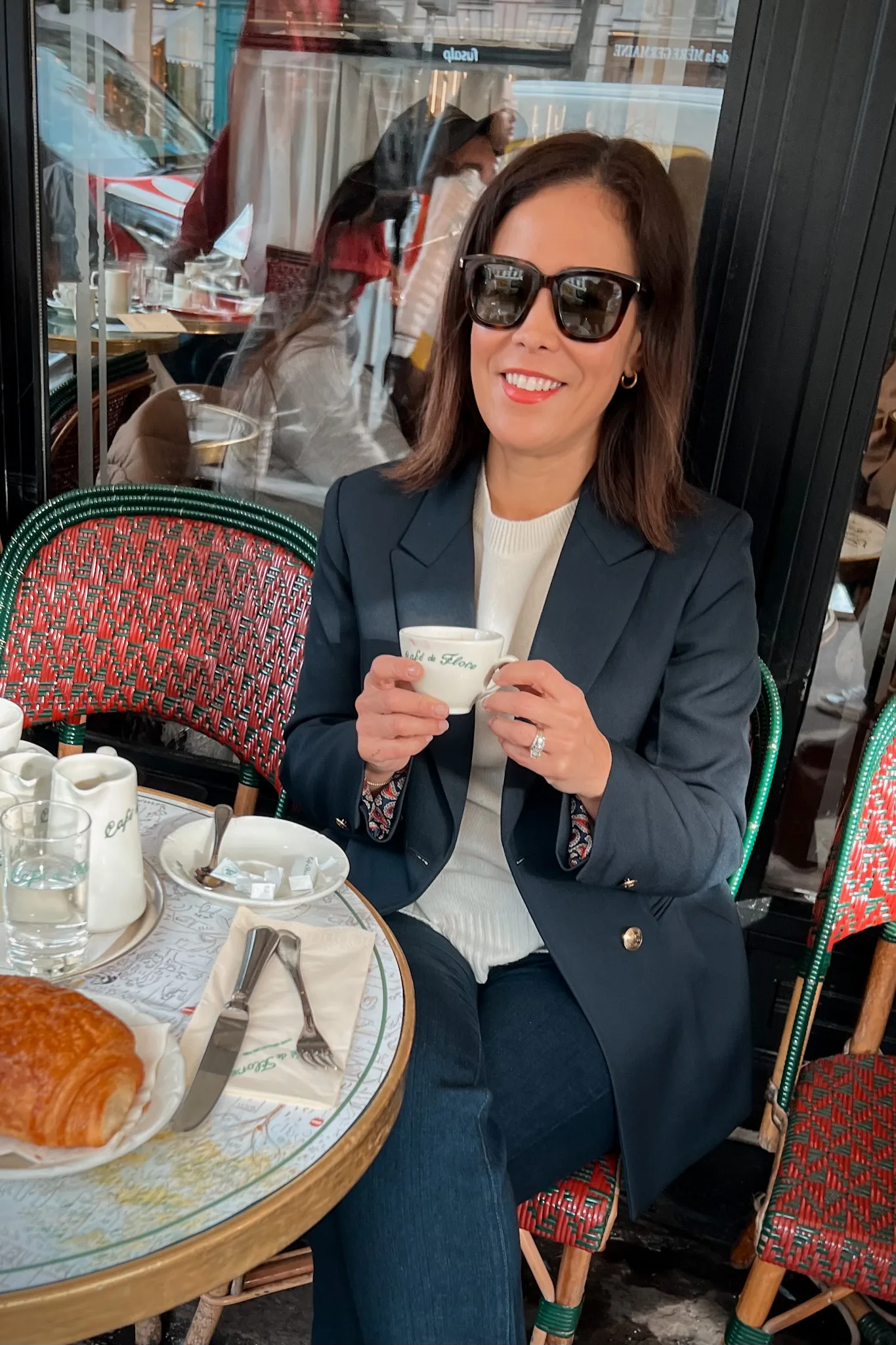 Ways to look chic and stylish in Paris during spring with a navy blazer and cashmere sweater.