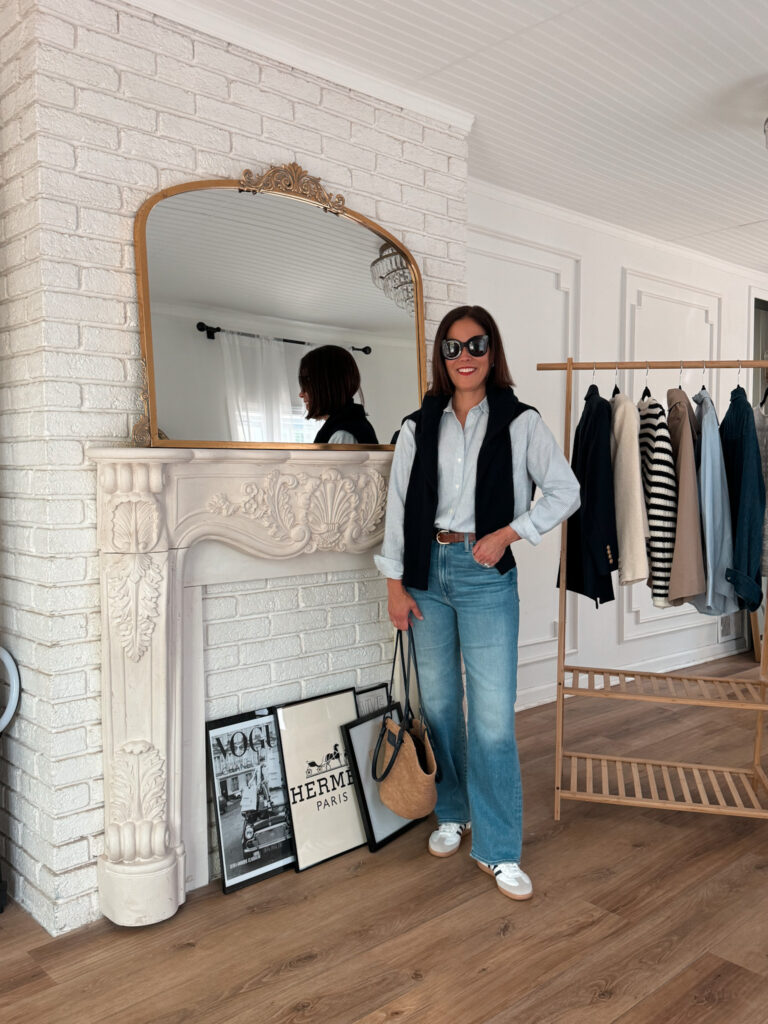 Woman wearing stripe top with denim and sneakers.