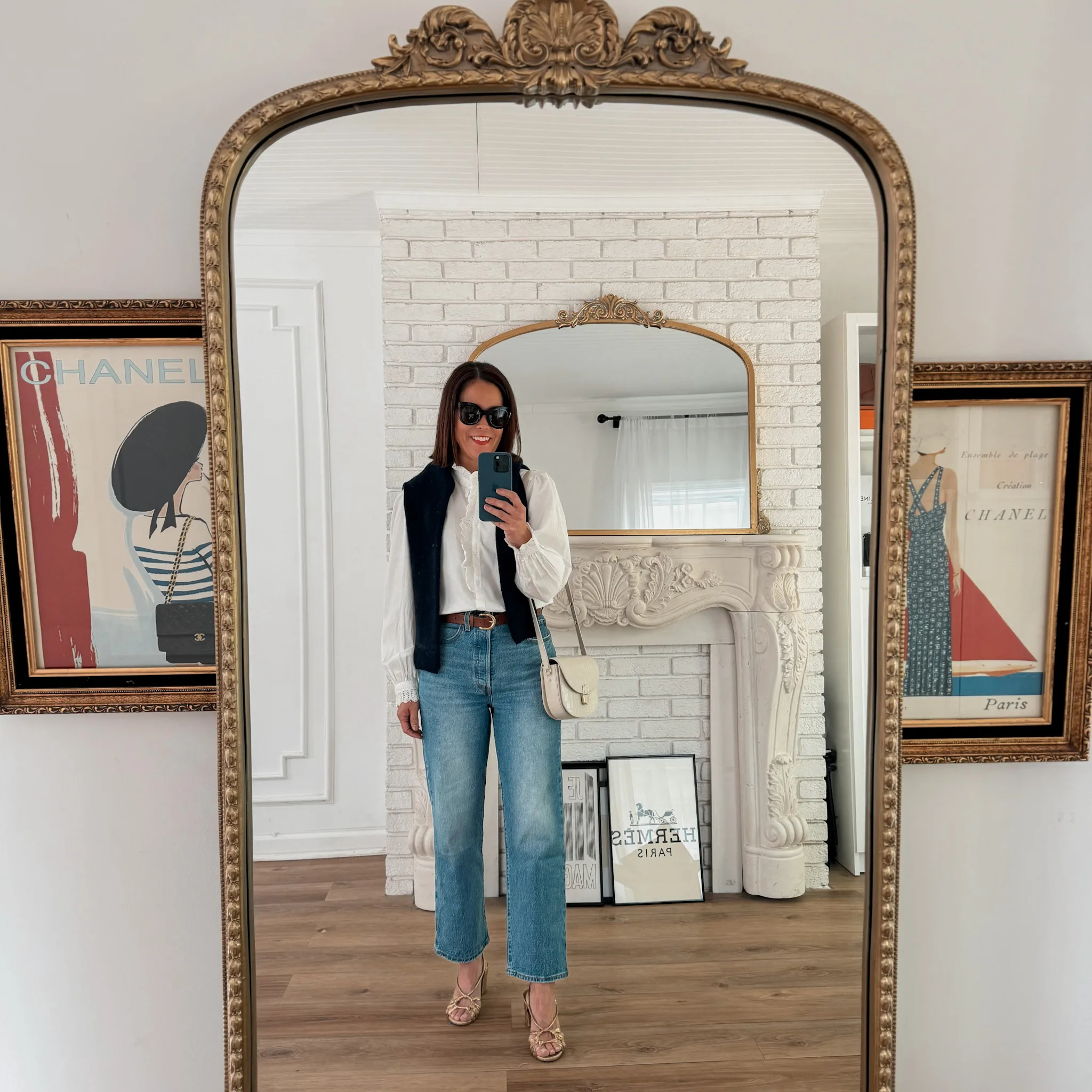 Woman wearing crop denim with white top and purse for chic French wardrobe basics.