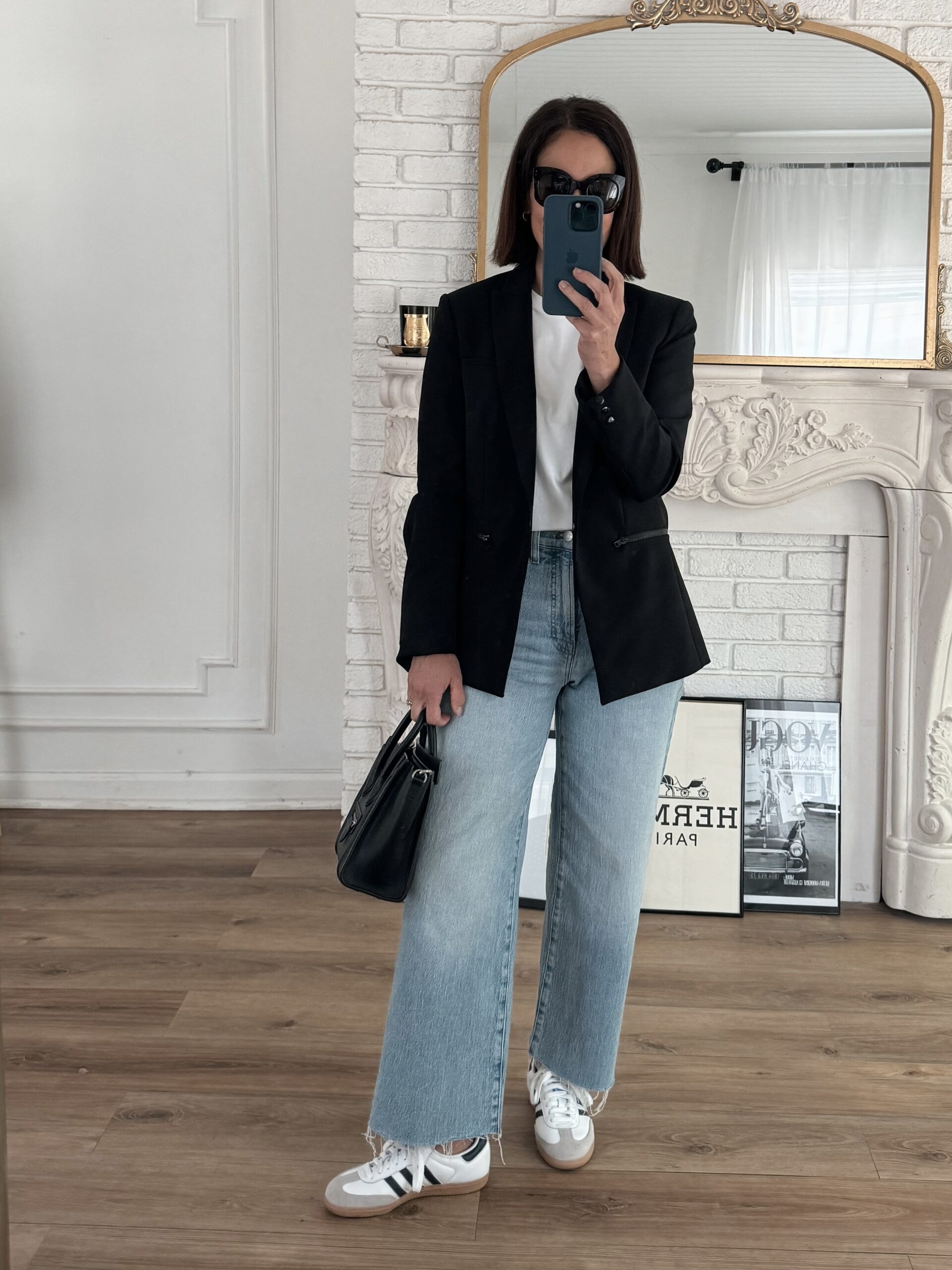 woman wearing black blazer with crop jeans and adidas samba.