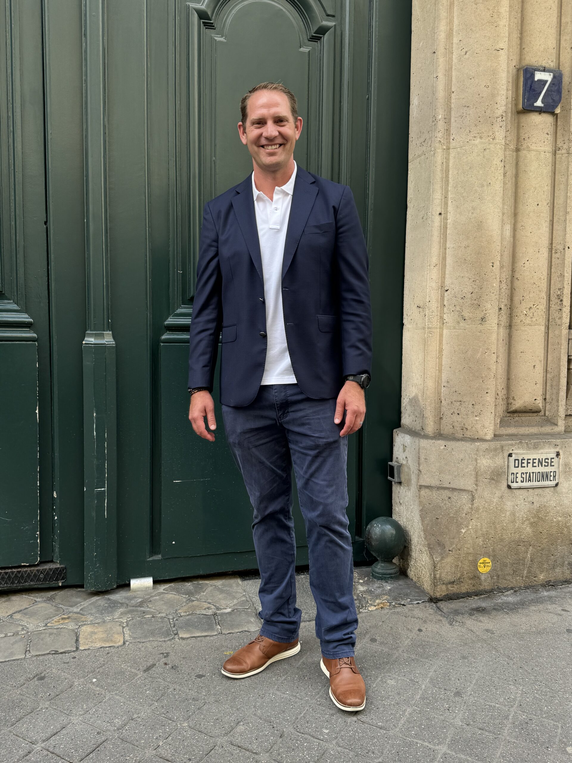 Man in navy blazer Man in navy blazer in front of green door in Paris.