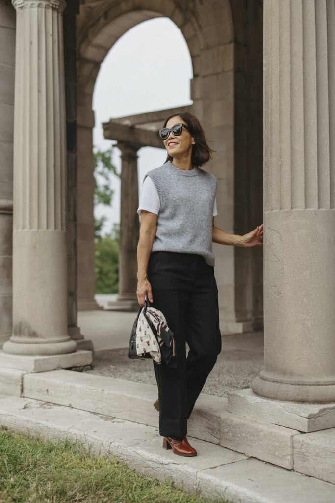 Lady wearing sezane grey vest with black pants.