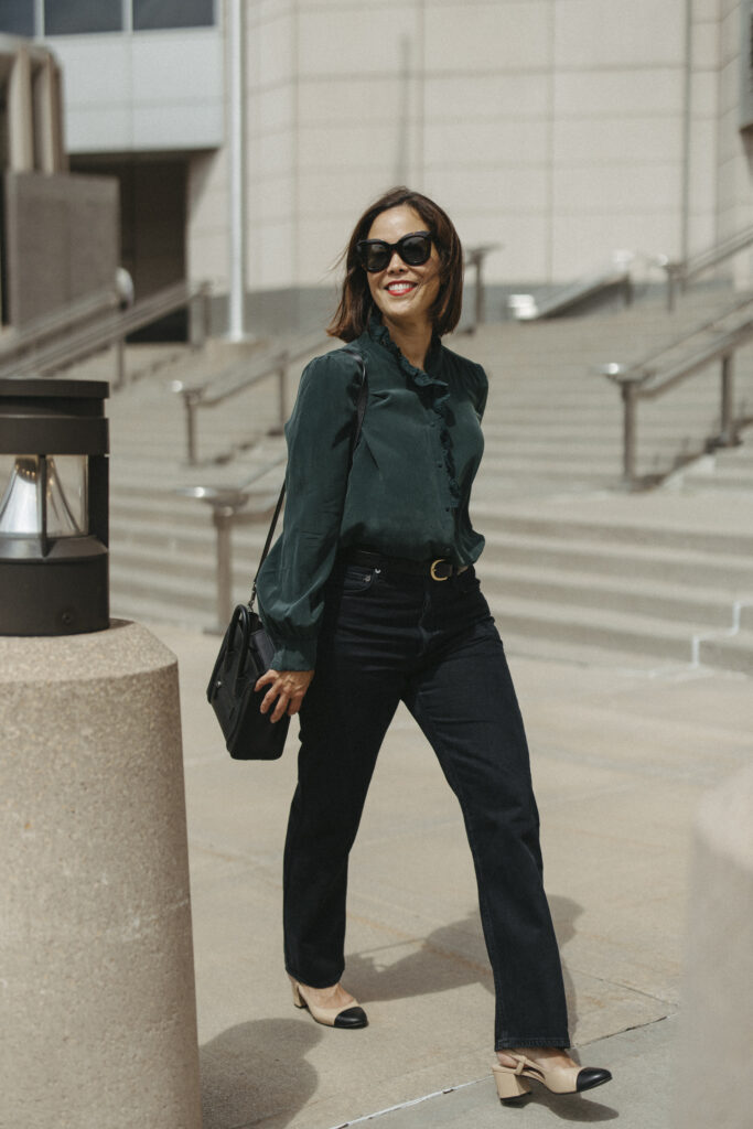Woman in green silk top walking | A Guide To Sézane Sizing