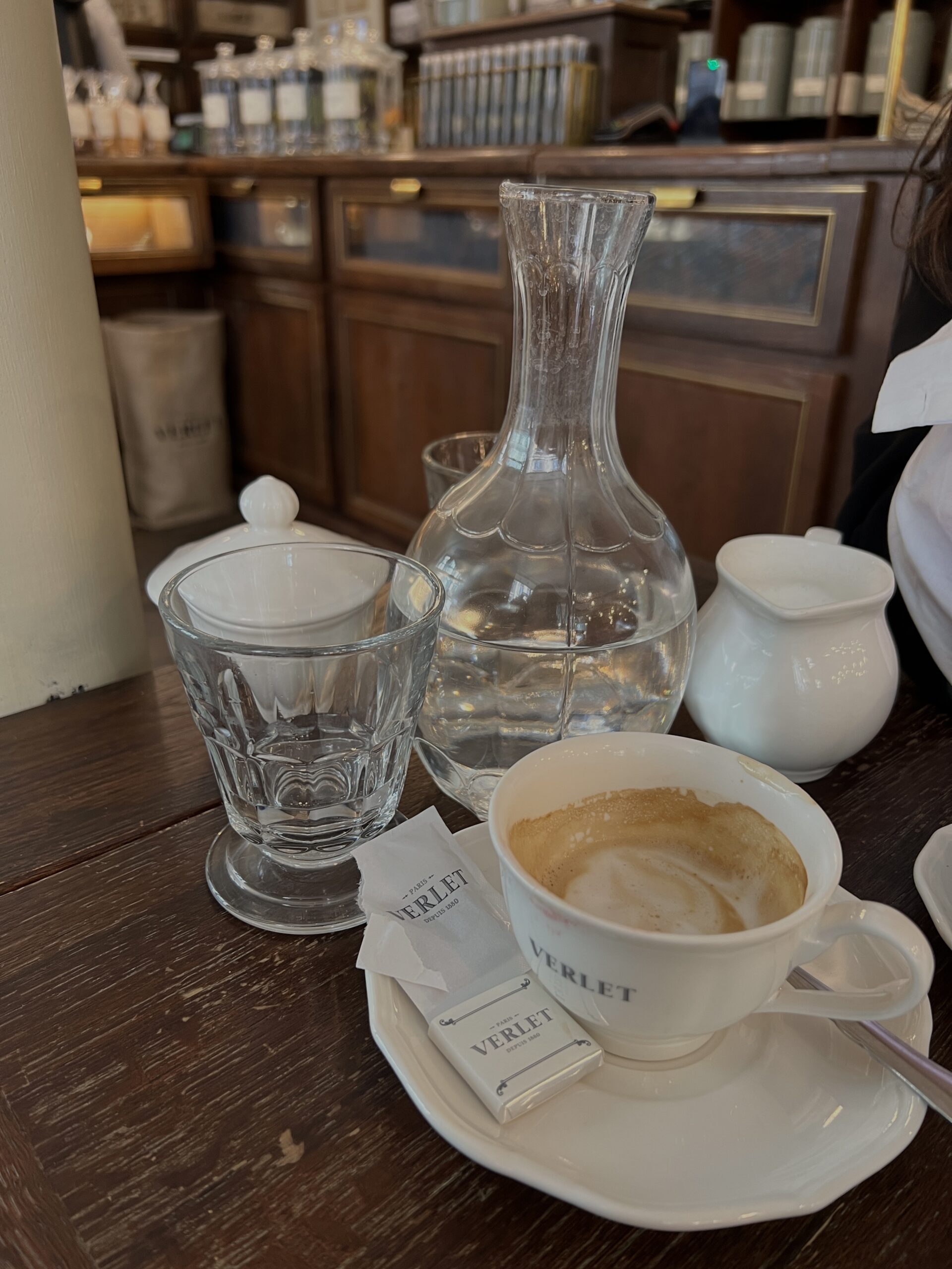 water bottle and latte on table at Cafe Verlet.