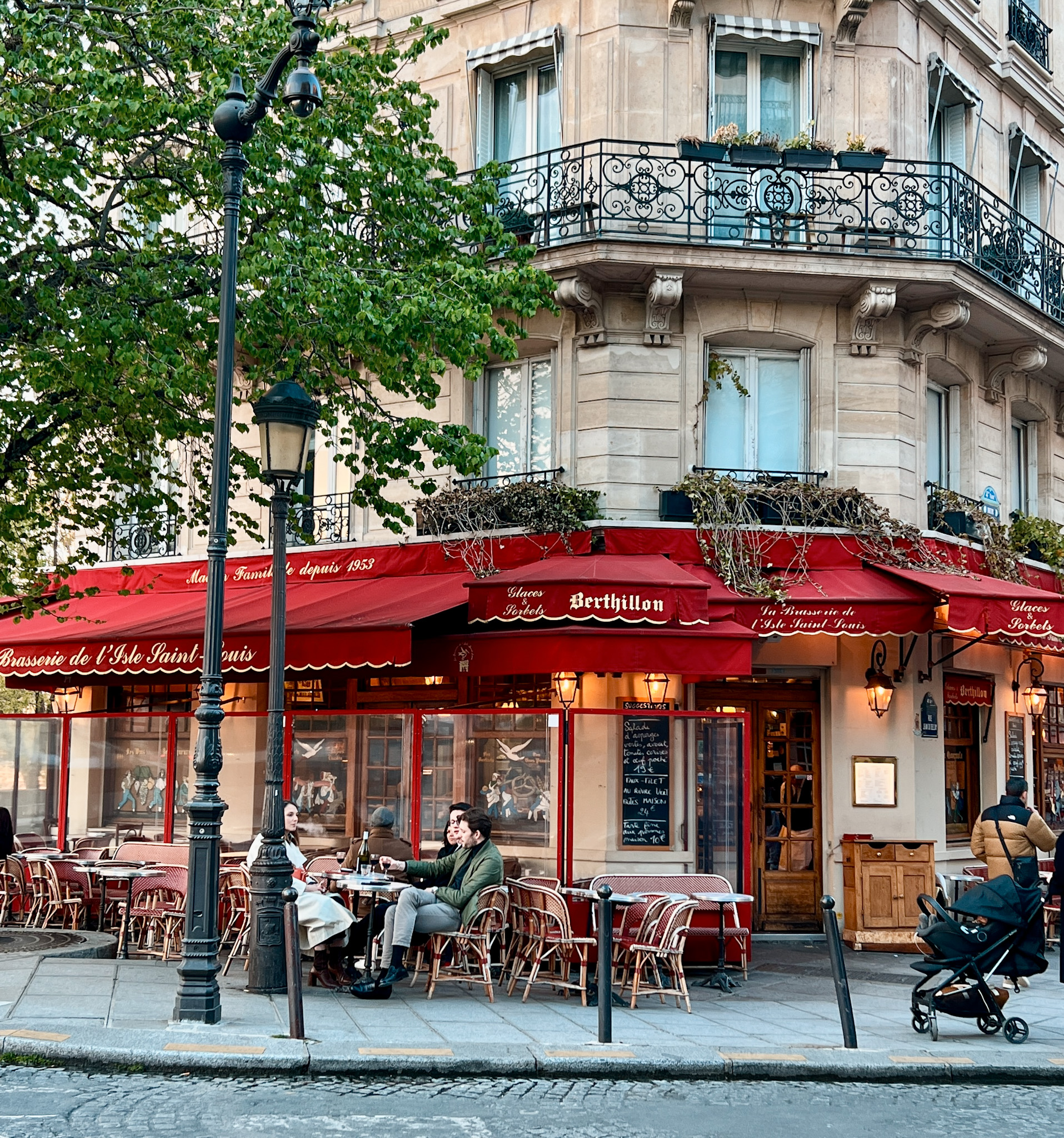 Exterior of cafe in Paris with red awning. 
