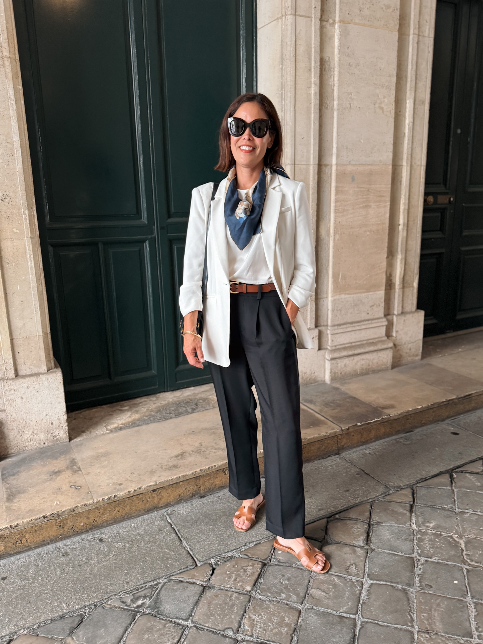 Girl wearing blazer with trousers and flats in Paris.