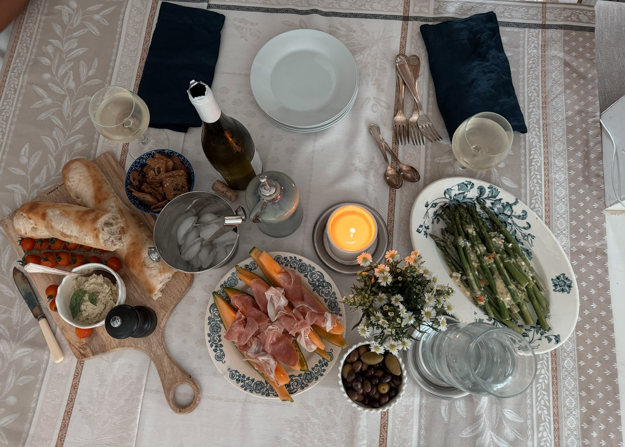 Tablescape showing what to serve at a french apero with wine, asparagus, veggies.