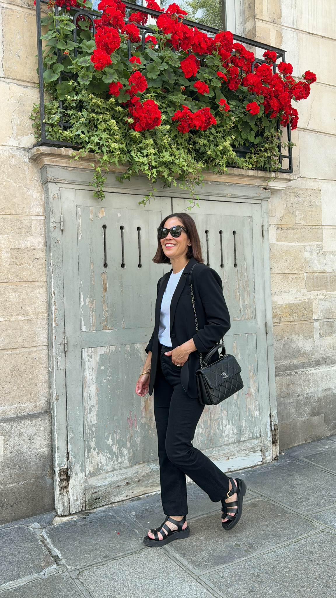 Woman wearing black blazer and pants walking in Paris | How I Started La Vie On Grand