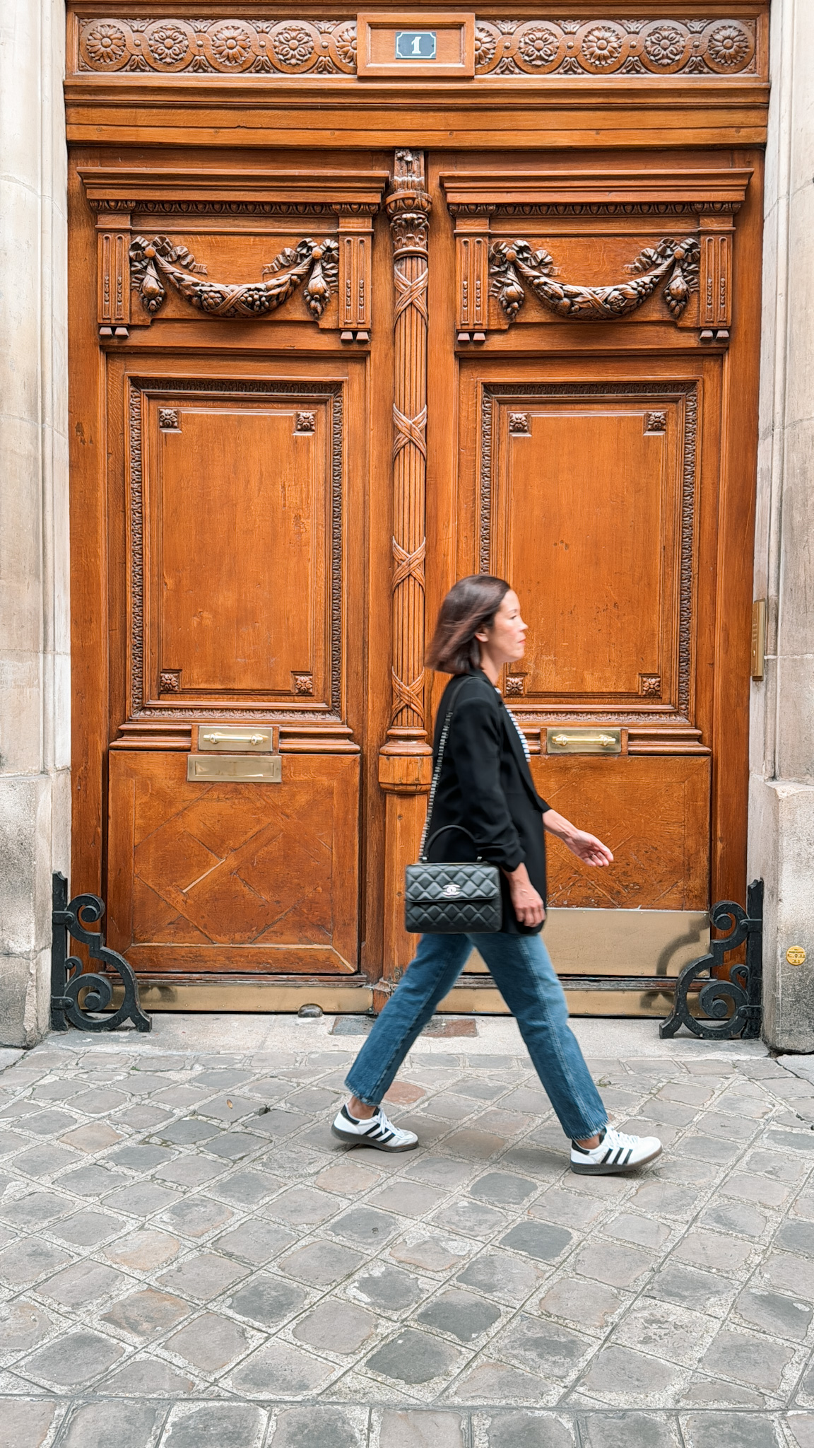 big brown doors paris Woman walking past big brown doors in Paris | Best Walking Shoes For Paris