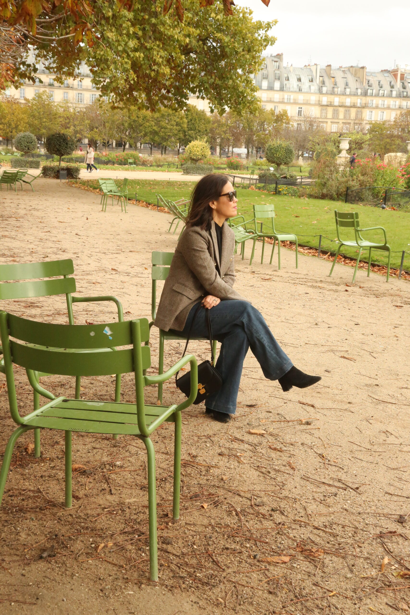 Tuileries garden in winter Woman sitting in Tuileries garden in Paris during winter.