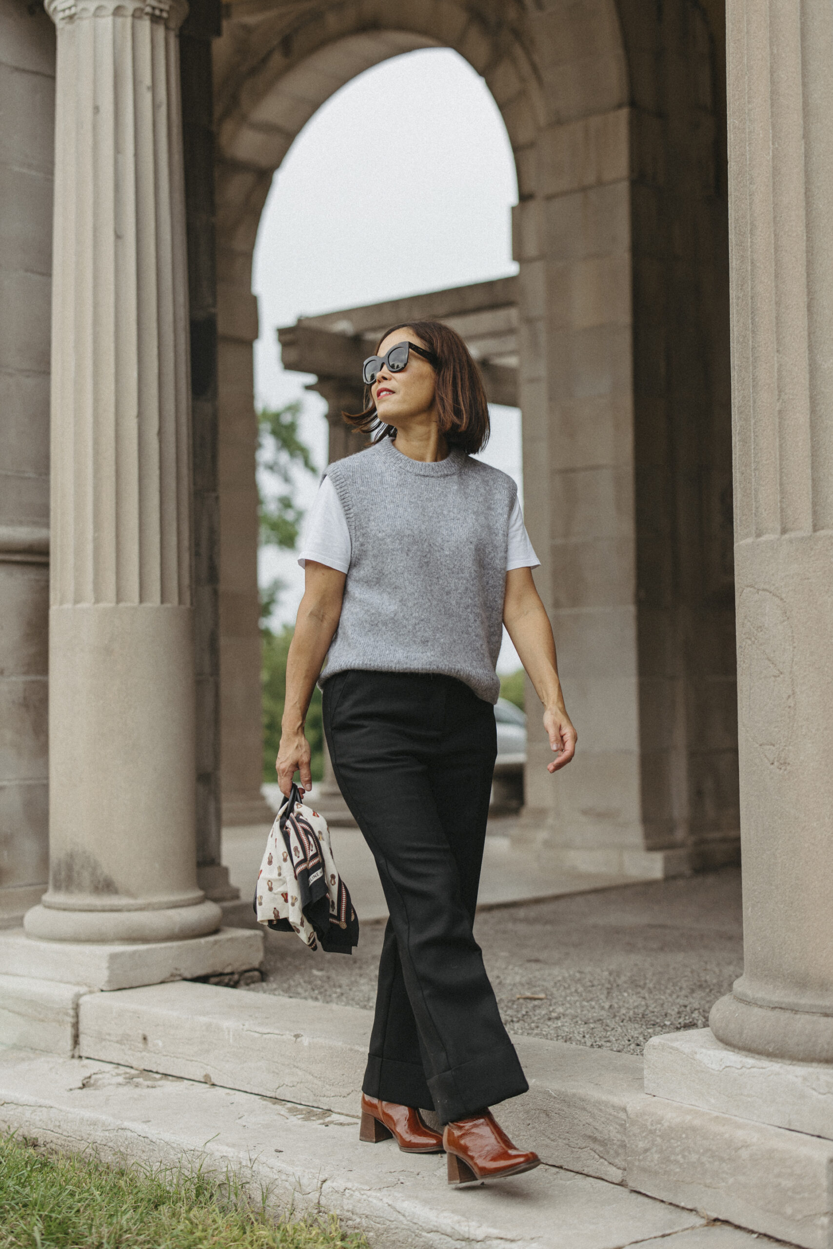 Grey sweater with black pants and boots.