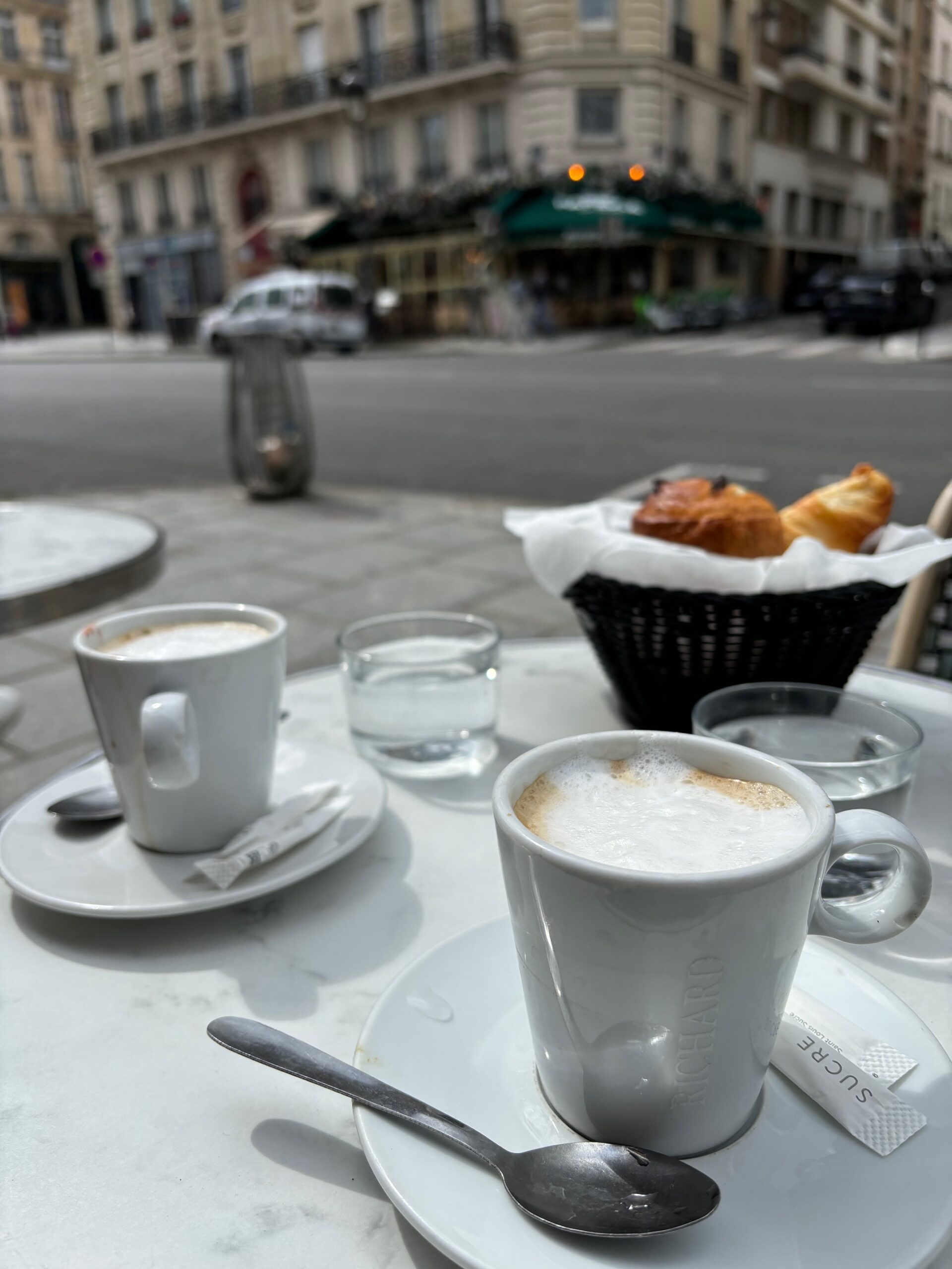 Paris cafe with croissants and coffee on the table.