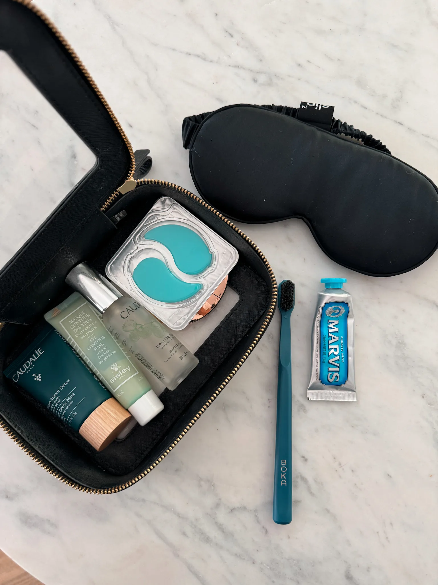 Picture of eye patches along with toothbrush for long flight essentials.