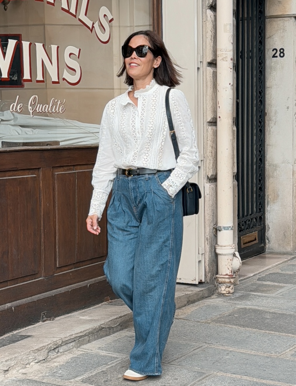 Woman wearing the Rym shirt in Paris in white. 