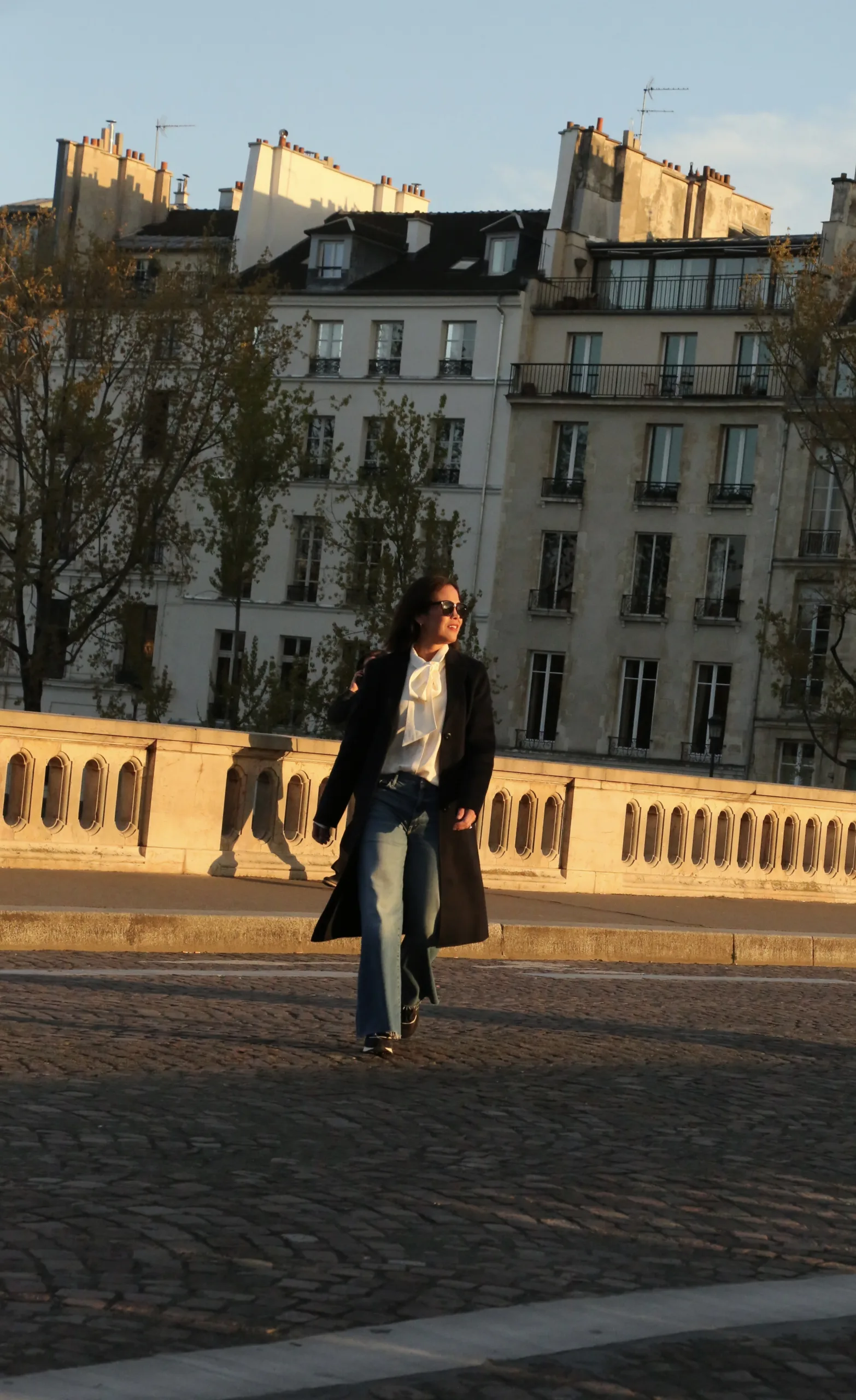 Woman with long wool coat and denim. 