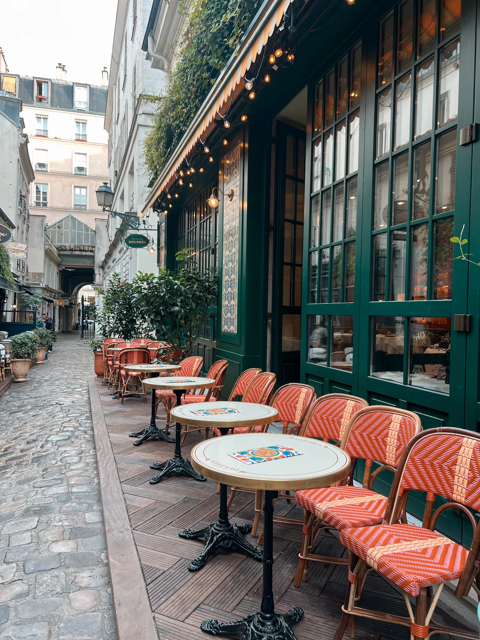 Woman in luxembourg gardens Picture of cafe tables and chairs in Paris for French Fridays.