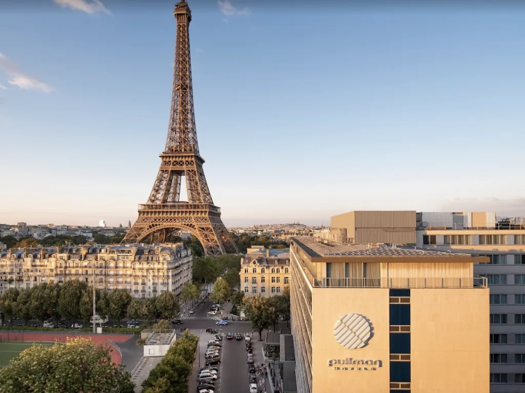 Eiffel Tower in the background of a photo of a hotel in Parisl.