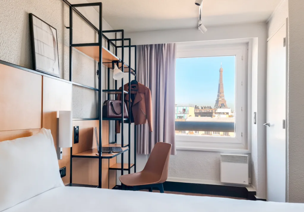 Exterior shot of hotel with eiffel tower in background.