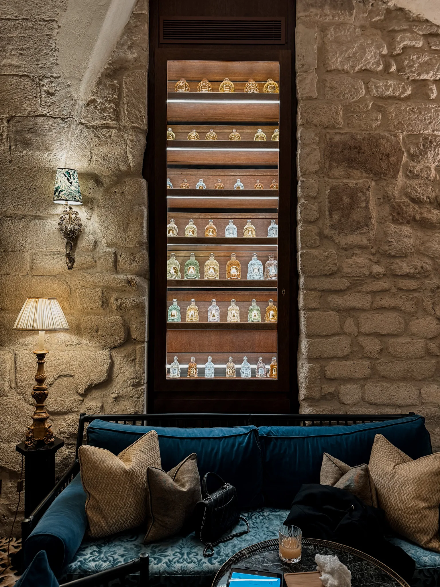 Bottles on a wall of a spa at the relais christine in Paris.