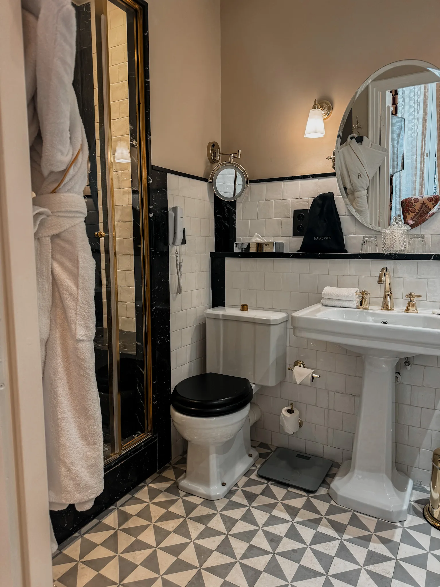 Bathroom with marble flooring in Paris hotel.