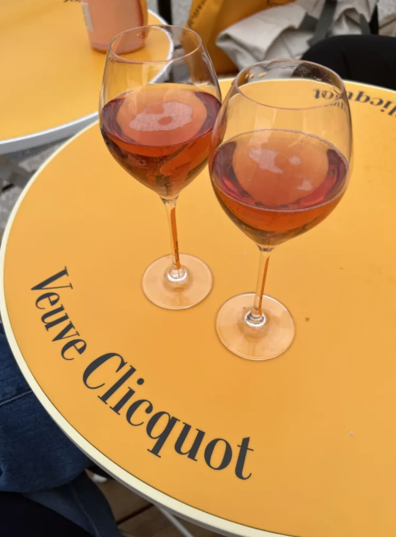 Picture of two champagne glasses sitting on table of Veuve Cliquot