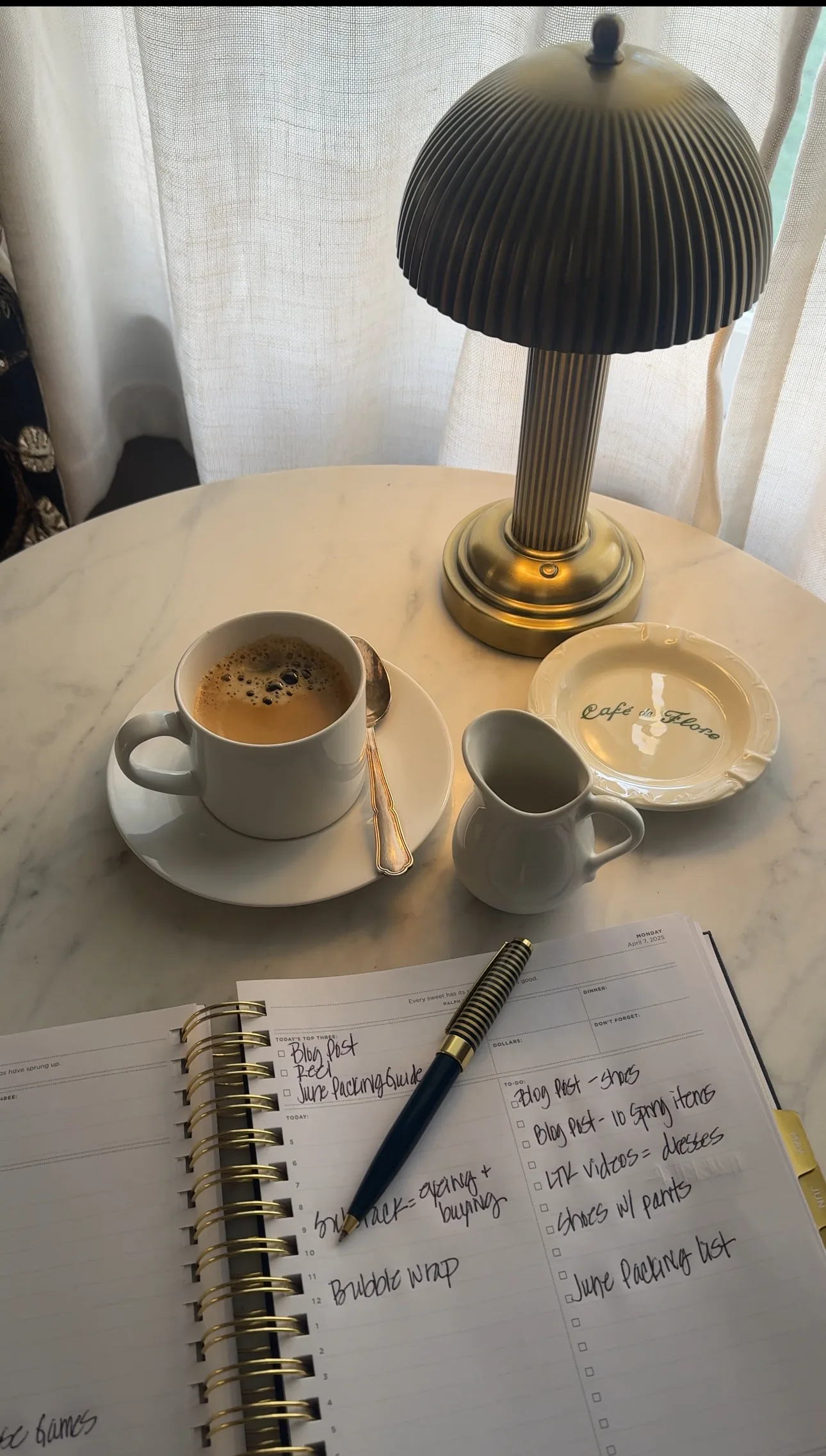 Coffee mug and lamp sitting on a table.