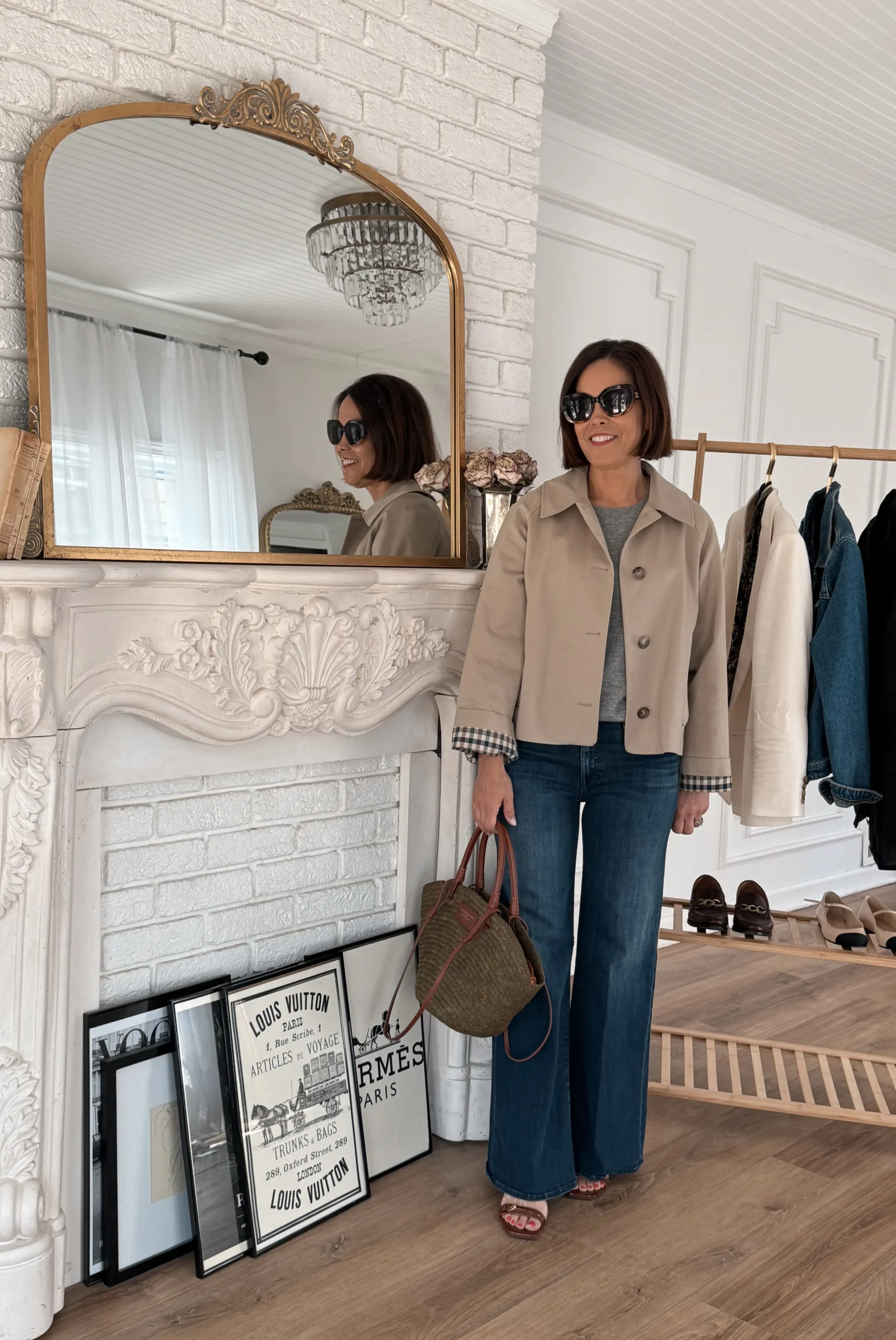 Woman wearing cropped trench coat with flare bottoms and sandals.