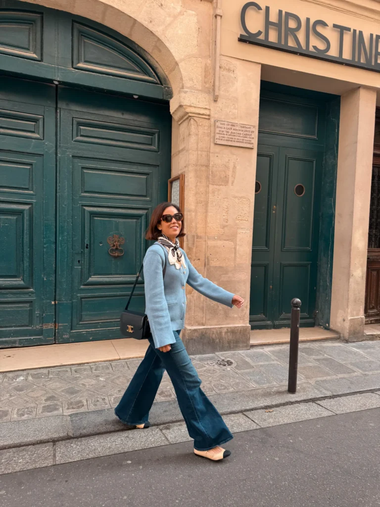 Woman in Paris in April with cardigan and denim and chanel ballet flats.