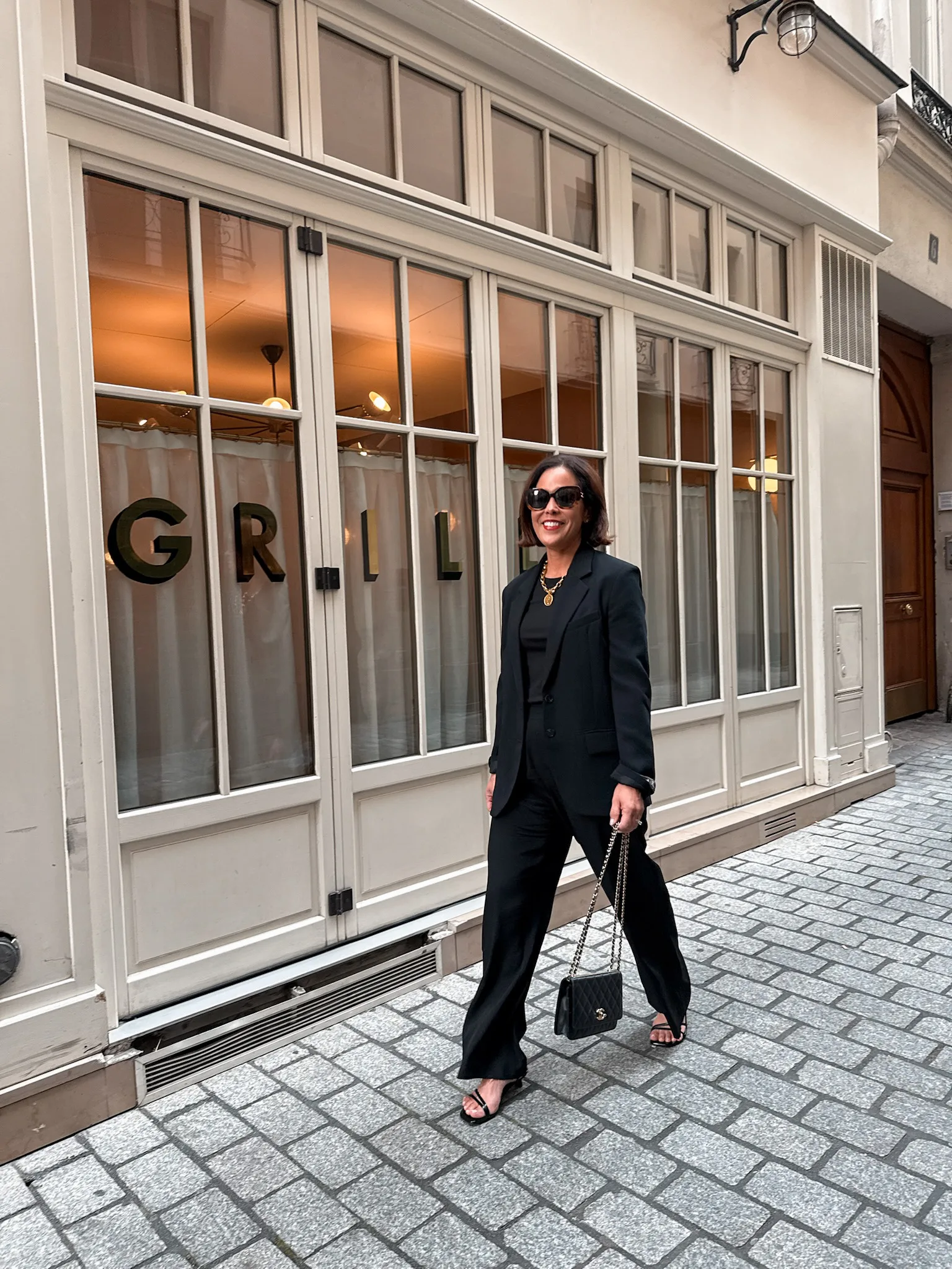 Woman wearing black jacket with black pants.