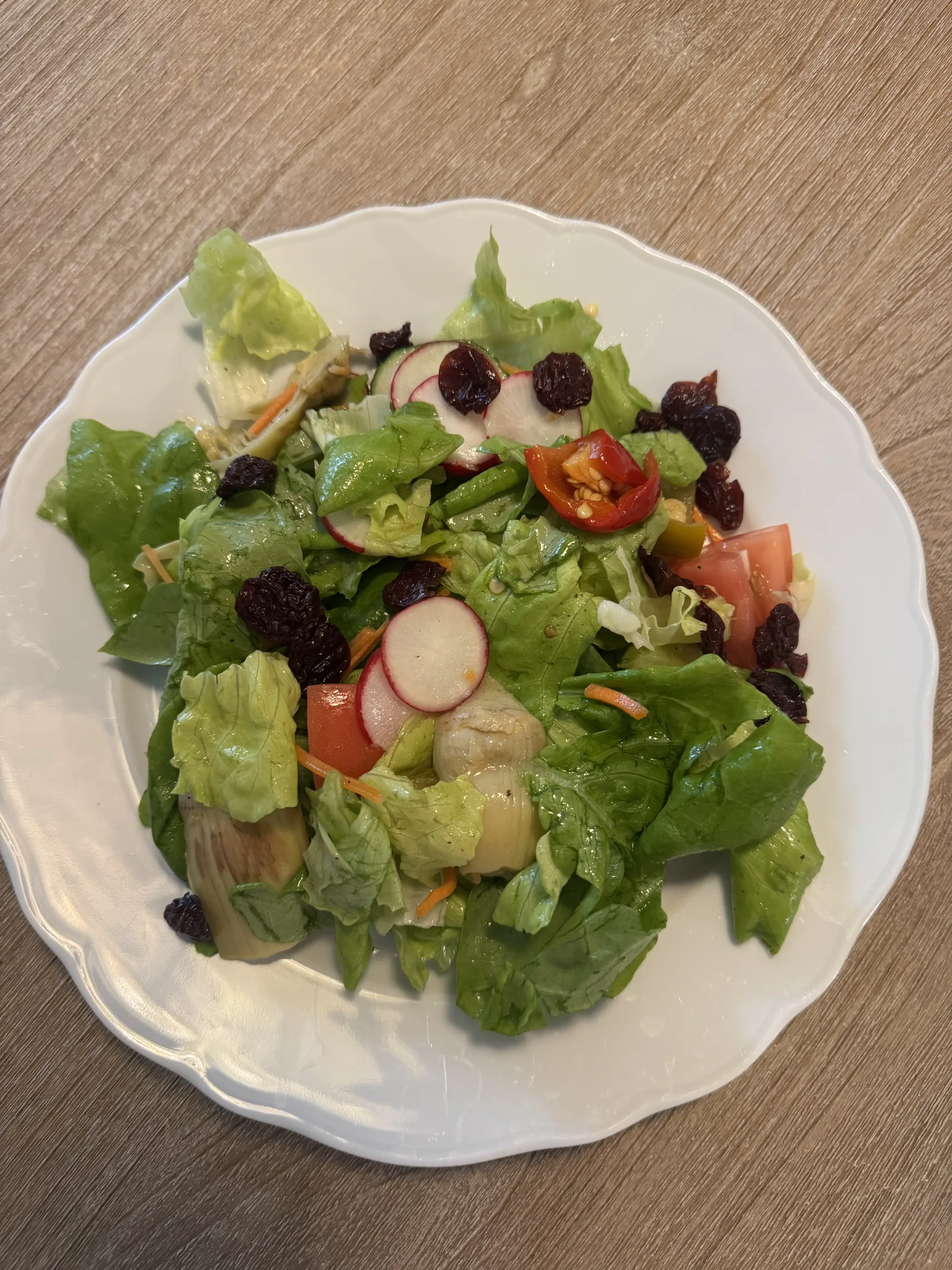 Green salad sitting on a table.