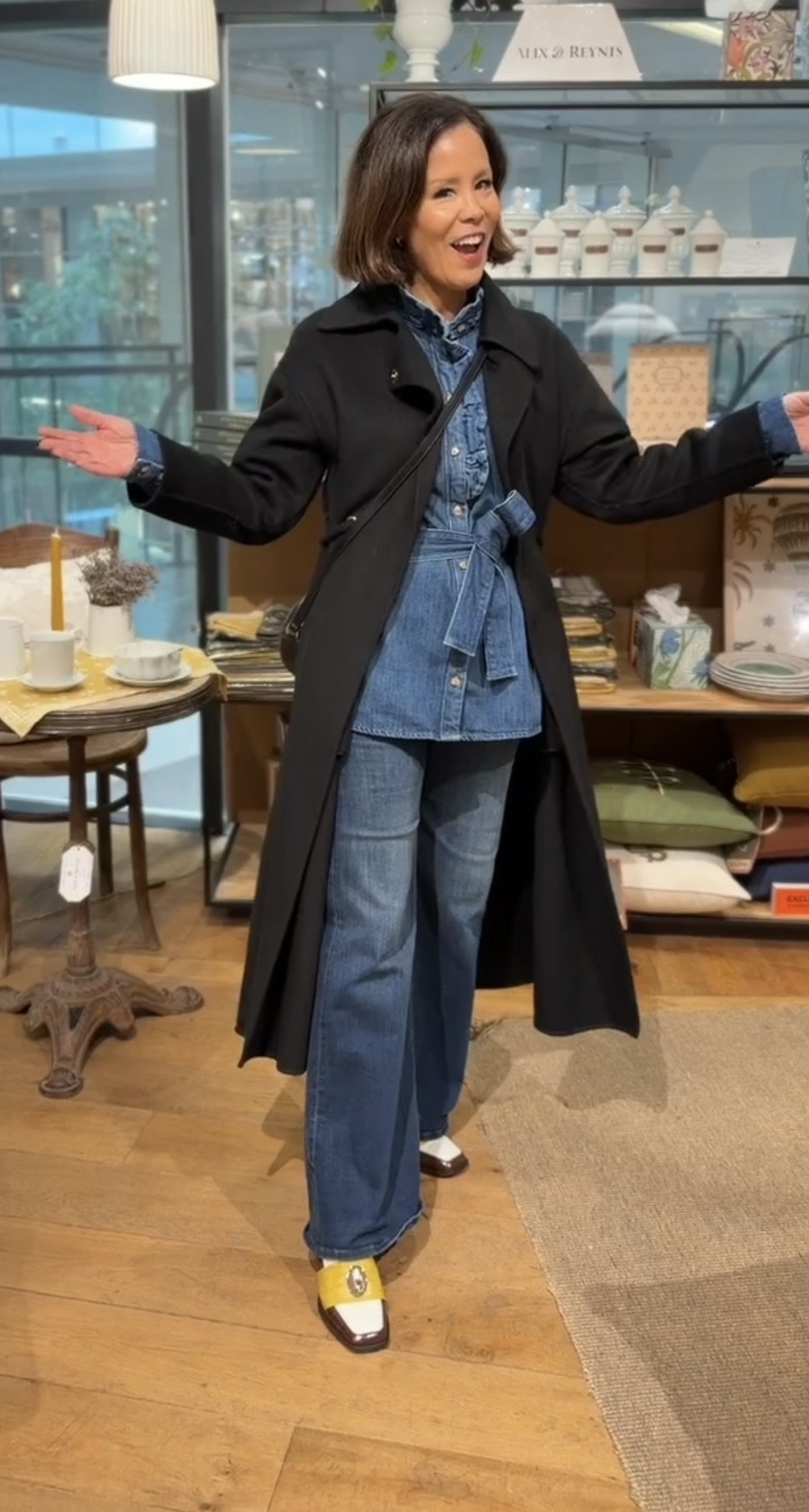 WOMAN WEARING DOUBLE DENIM WITH LONG WOOL BLACK COAT.