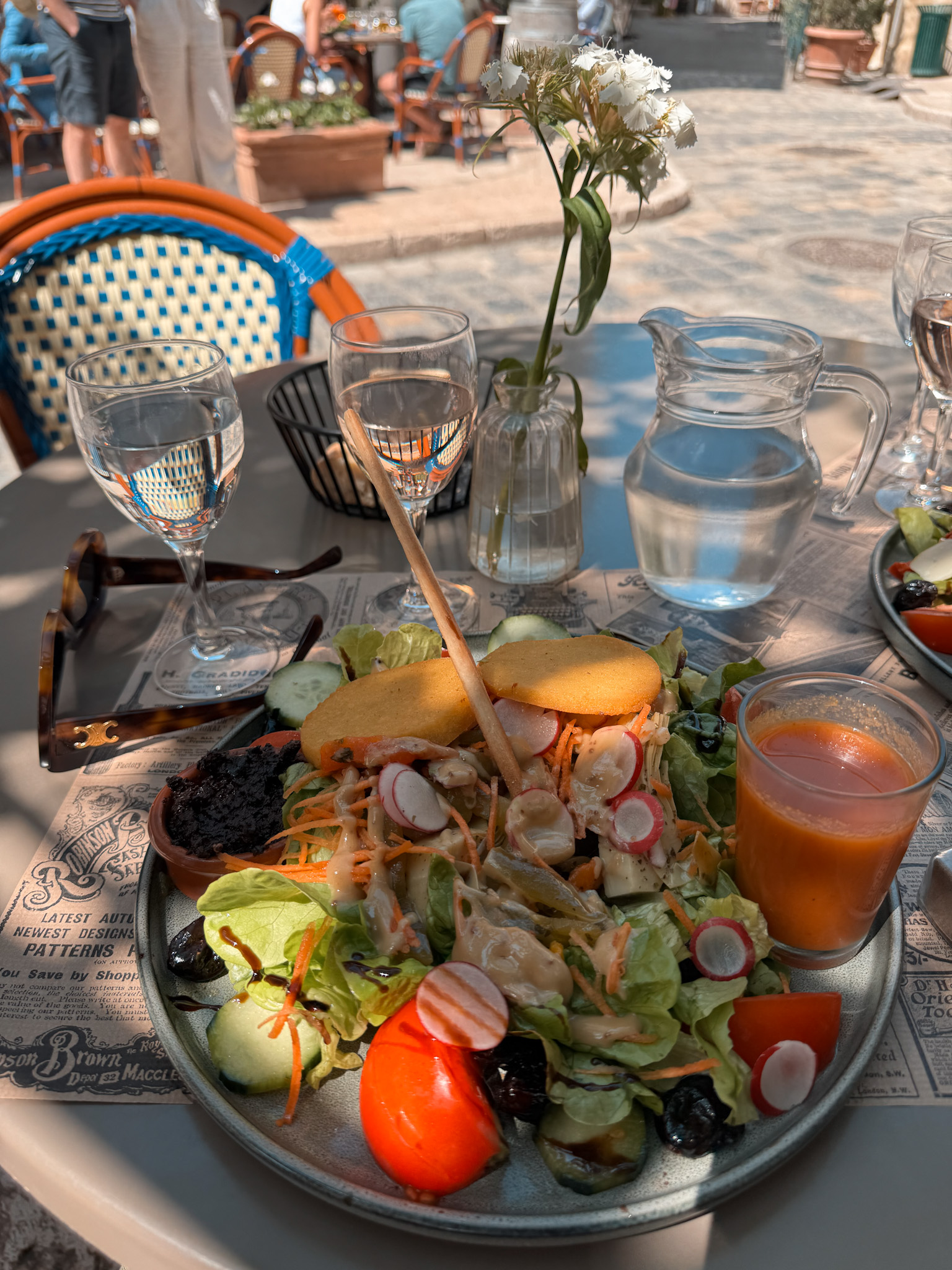 Outdoor lunch at Café Gaby in Lourmarin with fresh salad and café seating in the village square