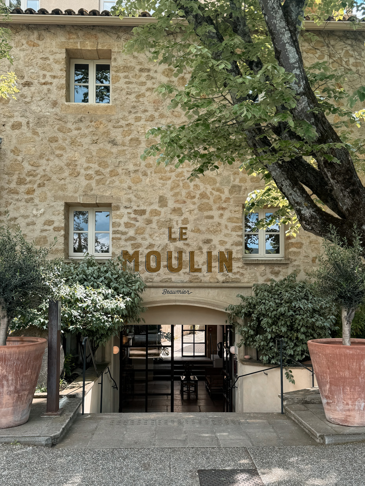Le Moulin Lourmarin boutique hotel exterior with stone facade in the village of Lourmarin, Provence