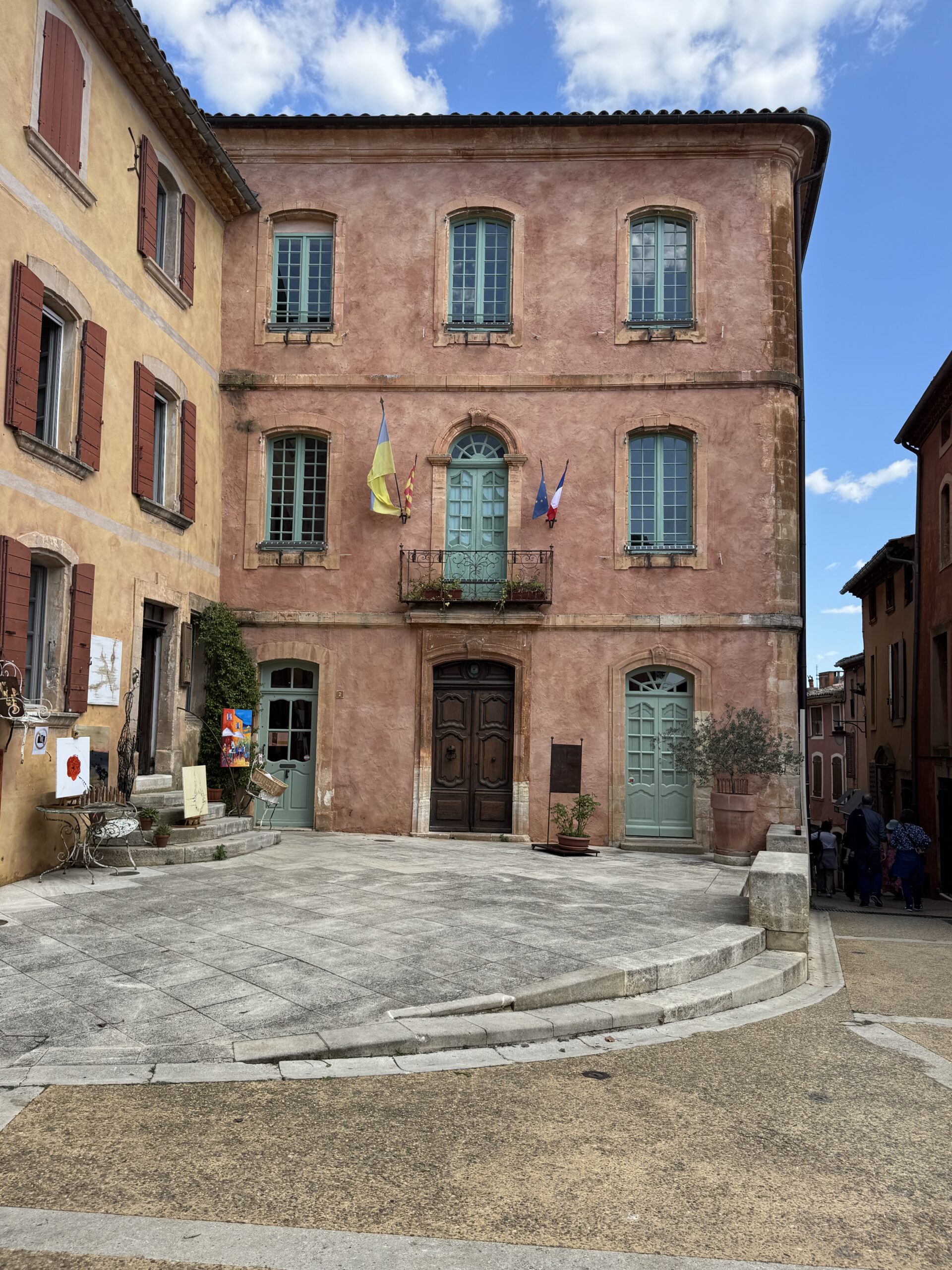 Ochre-colored buildings and village square in Roussillon, one of the most beautiful villages in the Luberon, Provence
